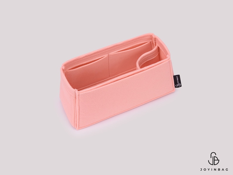 May include: A pink felt bag organizer with multiple compartments and a small black label with the text "Joyinbag".