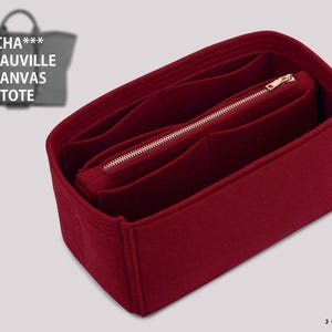 May include: A deep red felt bag organizer insert featuring multiple interior compartments and a central zippered pocket with a gold-toned metal zipper. The insert is designed for a CHA*** DEAUVILLE CANVAS TOTE, as indicated by the text in the corner.