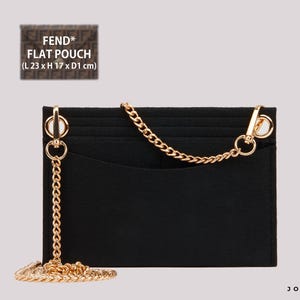 May include: Black felt pouch with a gold chain strap. The pouch has a card slot and the text "FEND* FLAT POUCH (L 23 x H 17 x D1 cm)" is printed on the front.