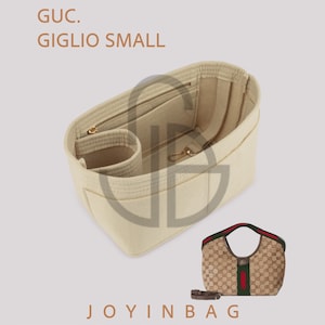 May include: Beige handbag organizer with multiple compartments and zippers. The text "GUC. GIGLIO SMALL" is visible. A matching handbag with a brown and beige pattern, red and green stripes, and a brown strap is also shown.