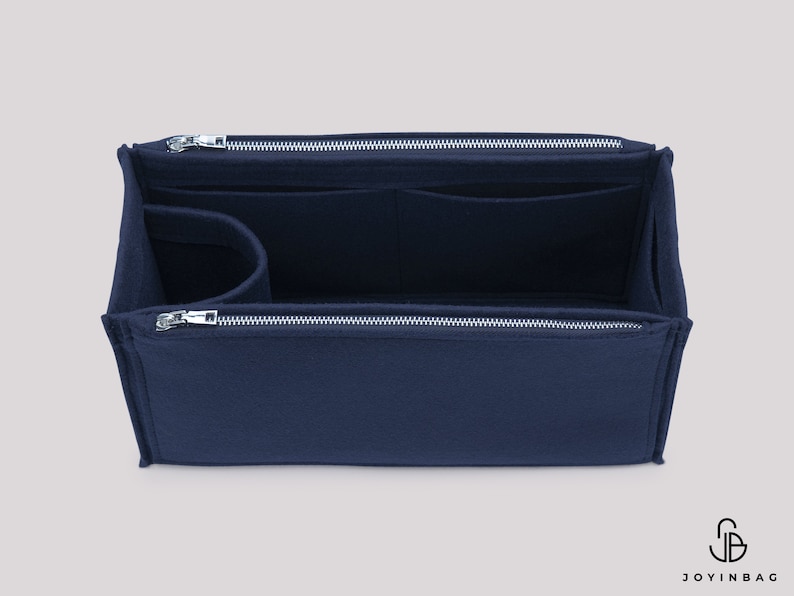 May include: A navy blue felt bag organiser with multiple compartments and a zipper closure. The organiser is designed to fit inside a larger bag and help keep it organised.