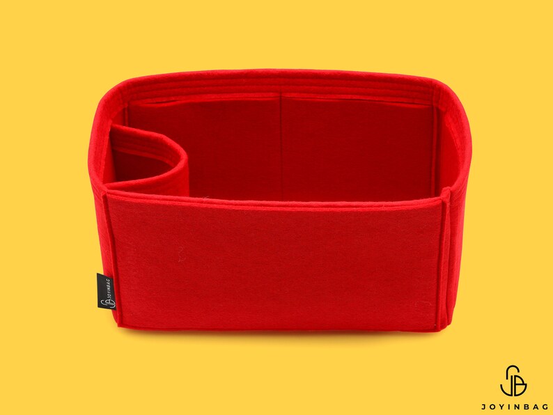 May include: Red felt bag insert with a single compartment and a small pocket on the side. The insert is designed to fit inside a handbag and help keep it organized.