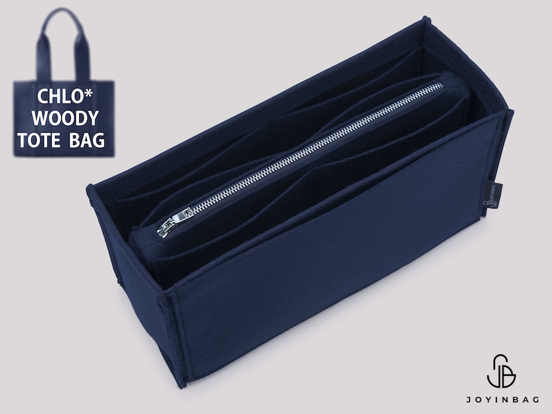 May include: A navy blue felt bag organizer with multiple compartments and a zippered pocket. The organizer is designed to fit inside a Chloe Woody Tote Bag.