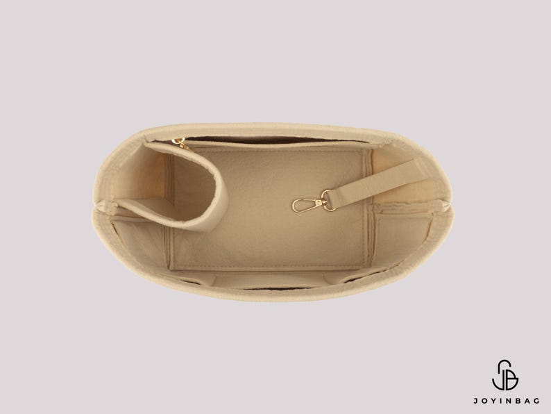 May include: Beige handbag organizer with multiple compartments, including a zippered pocket, a pen holder, and a key clip. The organizer is designed to fit inside a larger bag and keep items organized. The logo "JOYINBAG" is visible in the bottom right corner.