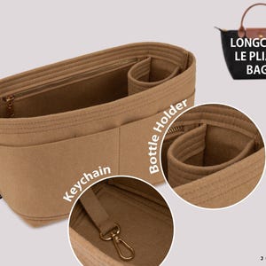 May include: A tan felt bag organiser insert featuring multiple interior compartments, a dedicated bottle holder, and a metal keychain clip. The insert is designed for Longch*** Le Pliage bags and includes a small black brand tag on the side.