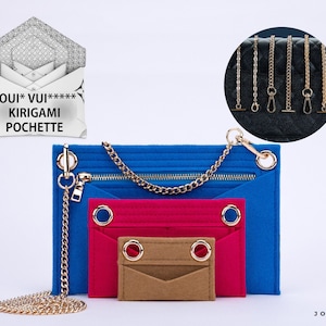 May include: Three felt envelope-style pouches in blue, pink, and tan, each featuring gold-tone metal grommets. A gold-tone chain strap attaches to the blue pouch. The image includes text reading LOUI* VUI***** KIRIGAMI POCHETTE and JOYINBAG.