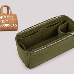 May include: An olive green felt handbag organiser insert featuring multiple interior compartments, a cylindrical side pocket, and two silver-toned metal zips. A blurred tan quilted handbag with the text CH******** DI** TOUJOURS BAG is visible.