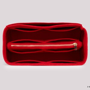 May include: Red felt bag organiser with multiple compartments and a zipped pocket. The organiser is designed to fit inside a larger bag.