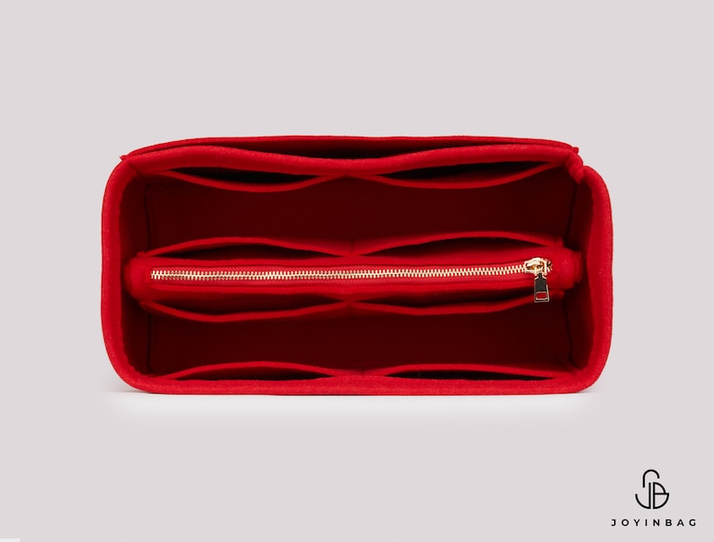 May include: Red felt bag organiser with multiple compartments and a zipped pocket. The organiser is designed to fit inside a larger bag.