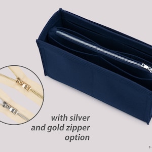 May include: A navy blue felt bag organizer with multiple compartments and a zipper closure. The zipper is available in silver and gold.