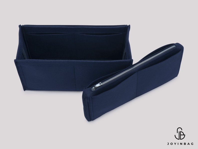 May include: A navy blue felt bag organizer with multiple compartments and a zippered pocket. The organizer is designed to fit inside a larger bag, helping to keep items organized.