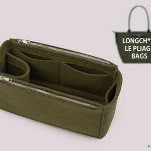 May include: Green felt bag organiser with multiple compartments and a zipper closure. The organiser is designed to fit inside a Longchamp Le Pliage bag. The text "LONGCH** LE PLIAGE BAGS" is visible on the bag.