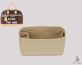 May include: A beige felt handbag organizer insert with multiple interior compartments and a cylindrical side pocket. The insert is designed for a brown monogrammed dome-shaped handbag, which is shown in the upper left corner with the text LOUI* VUI***** ALMA PM- MM.