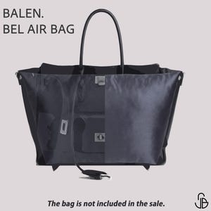 May include: A dark gray tote bag with a black handle, featuring the text "BALEN. BEL AIR BAG." The bag has a rectangular shape and a silver clasp. The text "The bag is not included in the sale" is also visible.