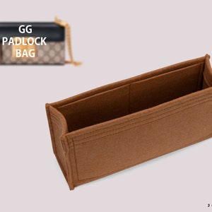 May include: A brown felt handbag organizer with two compartments. The organizer is designed to fit inside a GG Padlock Bag. The text "GG PADLOCK BAG" is visible in the background.