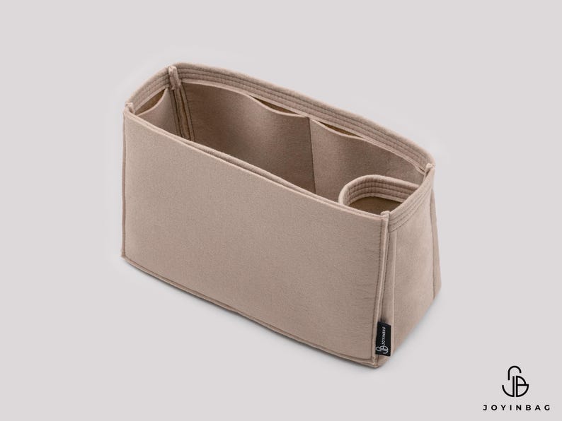 May include: Beige felt bag organizer with multiple compartments and a small pocket. The organizer is designed to fit inside a larger bag.