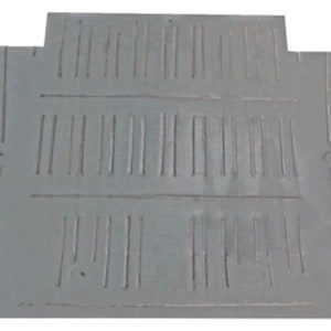 May include: A gray metal floor pan with cut-out sections and stamped lines. The floor pan has a rectangular shape with curved edges and is designed for a vehicle. The pan is made of durable metal.