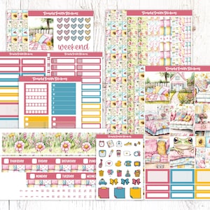 May include: A set of colourful planner stickers featuring a floral theme with a cottage and a frog. The stickers include a variety of shapes and sizes, including boxes, banners, and icons. The stickers are perfect for adding a touch of whimsy to your planner.