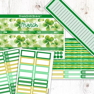 May include: A set of green and gold planner stickers with a watercolor shamrock pattern. The stickers include a monthly calendar, weekly planner, and various boxes and labels. The text "March" is featured on the monthly calendar.
