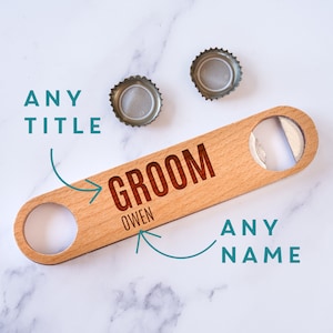 May include: Wooden bottle opener with a brown wood finish and a silver bottle opener. The text "Groom Owen" is engraved on the bottle opener.