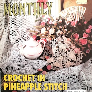 May include: A magazine cover featuring a crocheted pineapple stitch design. The cover features a teapot, a doily, and a bouquet of pink roses. The magazine title is "Crochet Monthly" and the text "Crochet in Pineapple Stitch" is featured in large, bold letters.