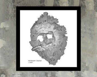 May include: A black and white topographic map of Newberry Crater in Oregon, showing the crater's shape and elevation. The text "Newberry Crater 7,089'" is at the bottom of the map.