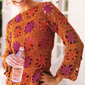 May include: A crochet top with a square pattern in orange and pink. The top has long sleeves and a loose fit.