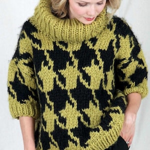 May include: A green and black knit sweater with a houndstooth pattern and a high turtleneck.