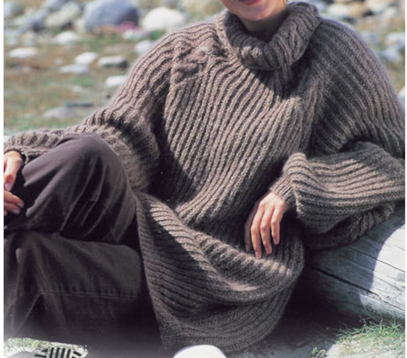 May include: A brown, knitted turtleneck sweater with a ribbed texture. The sweater is loose-fitting and has long sleeves.