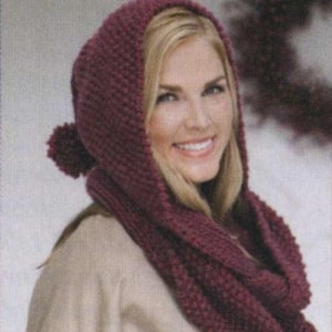 May include: A burgundy knitted hooded scarf with a pom-pom on the top of the hood.