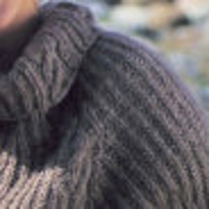May include: Close-up of a gray knitted sweater with a cable knit pattern. The sweater has a high neck and is made of a soft, textured yarn.