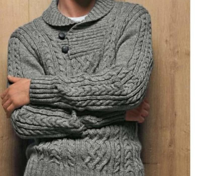 May include: A grey cable knit jumper with a collared neckline and a button fastening.