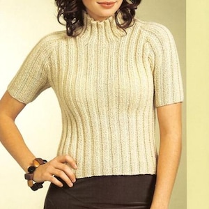 May include: A cream-colored knitted sweater with a high neck and short sleeves. The sweater has a ribbed texture.