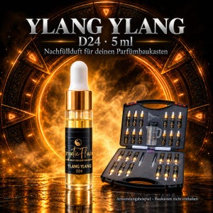 May include: A 5 ml glass dropper bottle of Ylang Ylang D24 fragrance oil with a gold collar and white cap, featuring a black label with the text Ylang Ylang D24. Beside it is an open black carrying case containing multiple small vials.