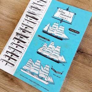 May include: A light blue book cover titled Royce's Sailing Illustrated Volume II. The cover features black and white illustrations of three large sailing ships labeled Star of India, Cutty Sark, and A.R.A. Libertad, plus a list of boat profiles.