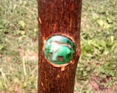43 quot Twisted Sweet Gum Walkingstick with a inlay grip, paracord wrist strap, glossy bark upper portion a green elephant centeriece.