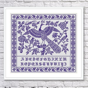 May include: A purple and white cross stitch sampler featuring a stylized phoenix bird surrounded by flowers and leaves. The sampler includes the alphabet in purple lettering. The title "Fenix Bird Sampler" is written in a decorative font below the sampler.