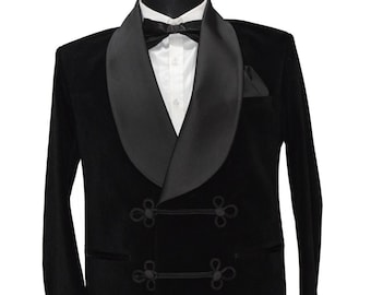 May include: A black velvet tuxedo jacket with a satin shawl collar and double-breasted closure. The jacket has decorative knot-like buttons and a pocket on the left side. The text "Ajirna Royal Designer" is visible at the bottom of the image.