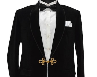 May include: A black velvet blazer with a shawl collar and gold rope closures. The blazer has a white shirt underneath and a black bow tie. The text "Ajirna Royal Designer" is visible in the bottom right corner.