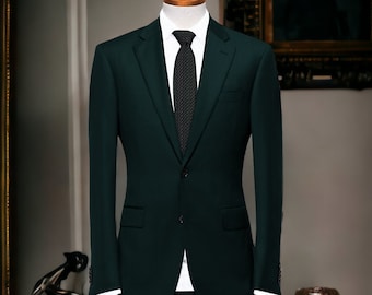 May include: A dark green suit with a white shirt and a dark patterned tie. The suit is on a mannequin and is displayed on a white dresser with a brown wooden top.