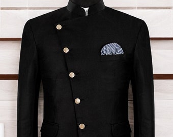 May include: A black blazer with a mandarin collar and gold buttons. The blazer has a single pocket on the left side and a pocket square in the right pocket.