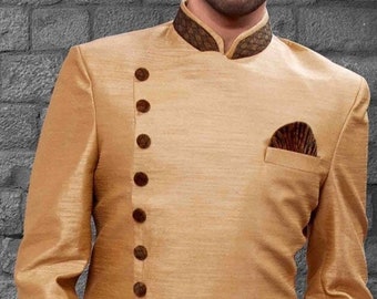 May include: A gold-colored long-sleeved jacket with a high collar and a diagonal row of buttons. The jacket has a pocket on the left side and a black fabric underneath.