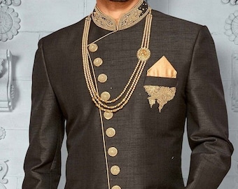 May include: A black long-sleeved jacket with gold buttons and a gold trim. The jacket has a mandarin collar with gold embroidery. The jacket is worn over a gold shirt.