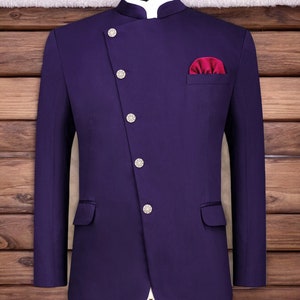 May include: A purple blazer with a mandarin collar and five silver buttons. The blazer has a single pocket on the left side and a red pocket square on the right side.