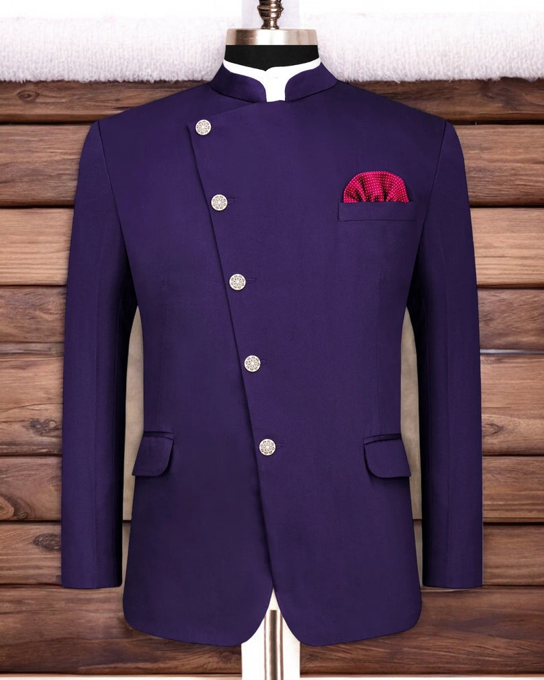 May include: A purple blazer with a mandarin collar and five silver buttons. The blazer has a single pocket on the left side and a red pocket square on the right side.