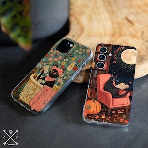 May include: Two phone cases with whimsical cat illustrations. One case features a black cat in a floral bath, wearing glasses and a pink headscarf. The other depicts a black cat reading in a chair with a full moon and pumpkin.