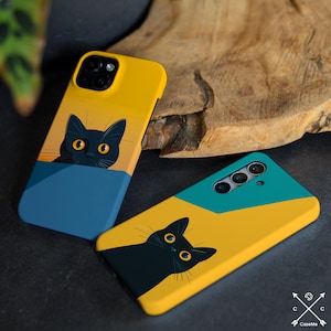 May include: Two phone cases with a black cat design. One case is yellow with a blue background and the other is yellow with a teal background. Both cases feature a black cat with large, yellow eyes.