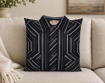May include: A square throw pillow constructed from a black and white striped button-down shirt. The pillow features a pointed collar, a central button placket with visible metal snaps, and two chest pockets with flaps. A Wrangler brand label is visible.