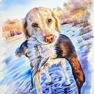 May include: A watercolor painting of a golden-colored dog standing in blue water, holding a dark-feathered bird in its mouth. The background features soft, warm-toned brushstrokes of orange and yellow, contrasting with the cool blue water.