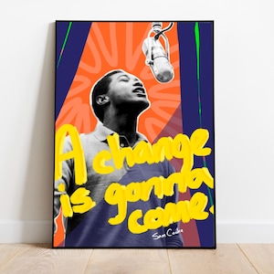 Peut inclure: Une affiche encadrée avec une image en noir et blanc d'un homme chantant dans un microphone. Les mots "A change is gonna come" sont écrits en jaune, avec le nom de l'artiste en dessous. Le fond est orange et bleu.